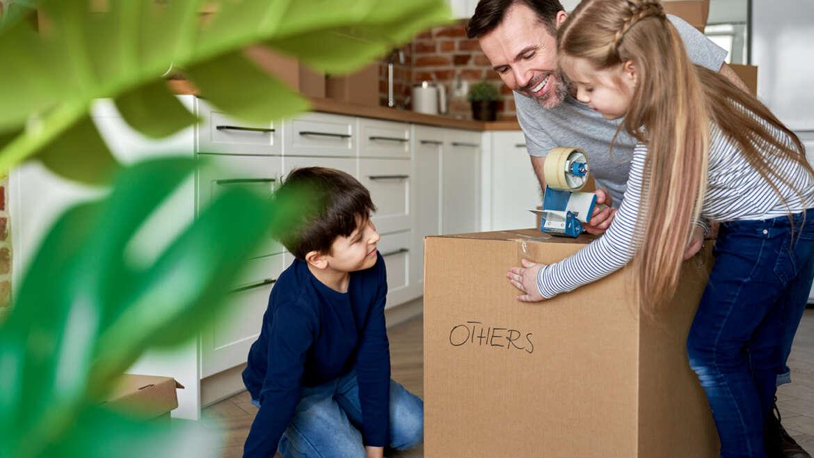 Moving with Kids children help their father packing cardboard boxes R99G9JS 1170x658 1