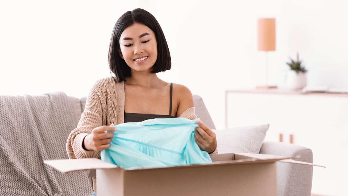 How to Pack Clothes for Moving happy asian lady packing clothes at home PPCSP88 1170x658 1