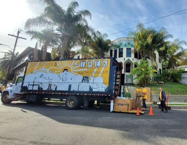 Three men and a moving truck. Preparation for a long distance residential relocation.