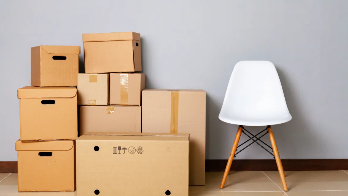 How Much Do Movers Cost? moving boxes with packed stuff and chair for movin 2021 11 01 01 43 44 utc