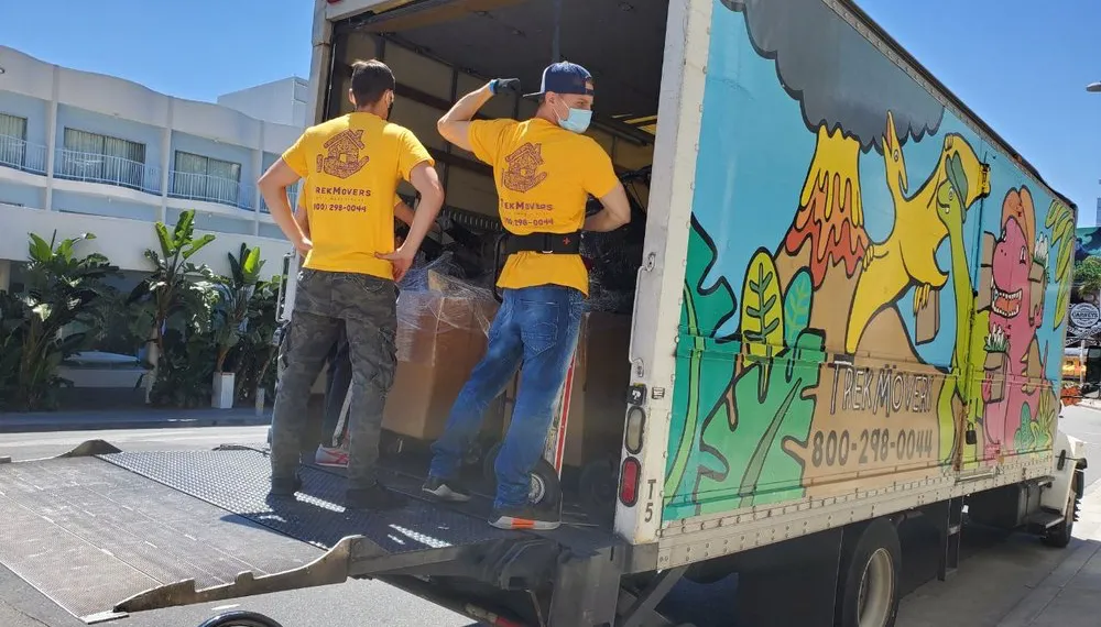 Movers loading boxes into a truck, TrekMovers