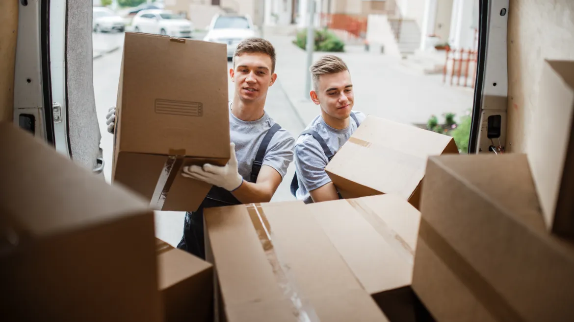 Full-Service Moving Companies: What Services Do They Offer? two young handsome smiling movers wearing uniforms 2021 08 26 20 10 58 utc