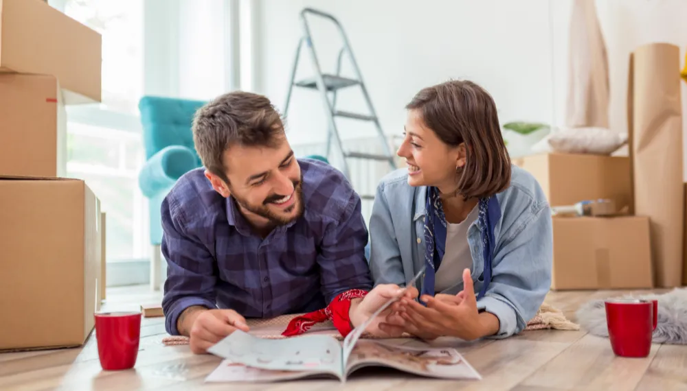 Couple reading a magazine while planning their move, TrekMovers