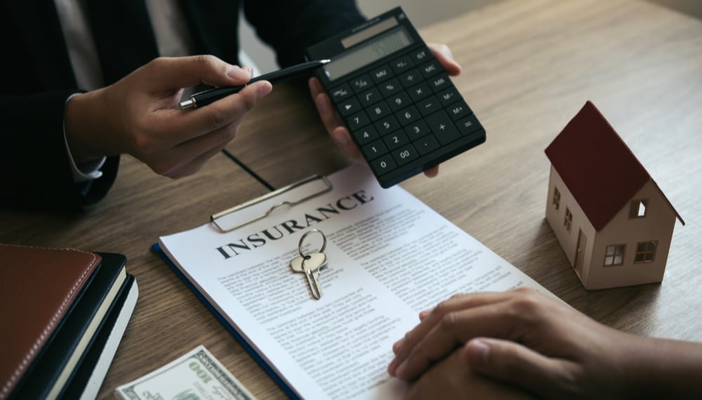 Calculator on a desk next to moving documents, TrekMovers