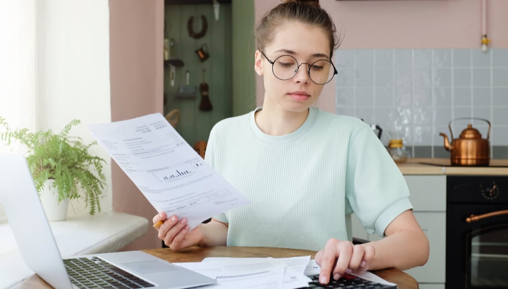 Woman reviewing moving documents and paperwork, TrekMovers