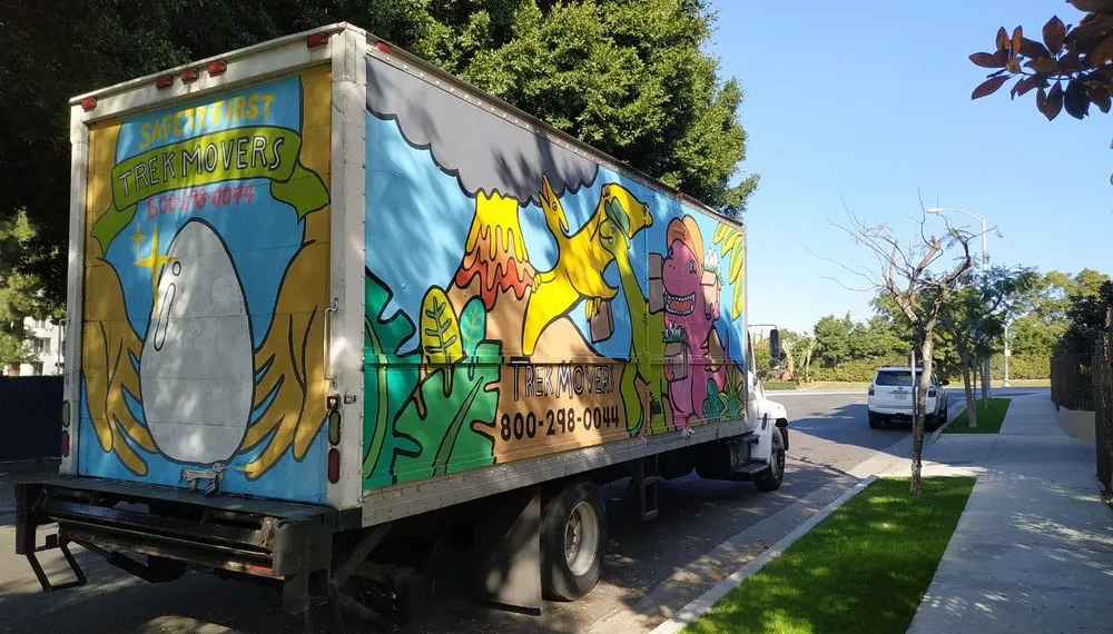 Relocation boxes in front of a classic small-town home, TrekMovers