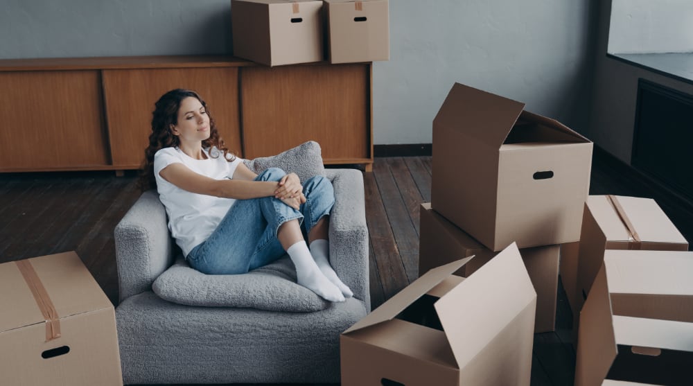 How to Pack for a Move — A Complete Guide relaxed woman rests in armchair during packing thi 2022 09 13 22 04 32 utc