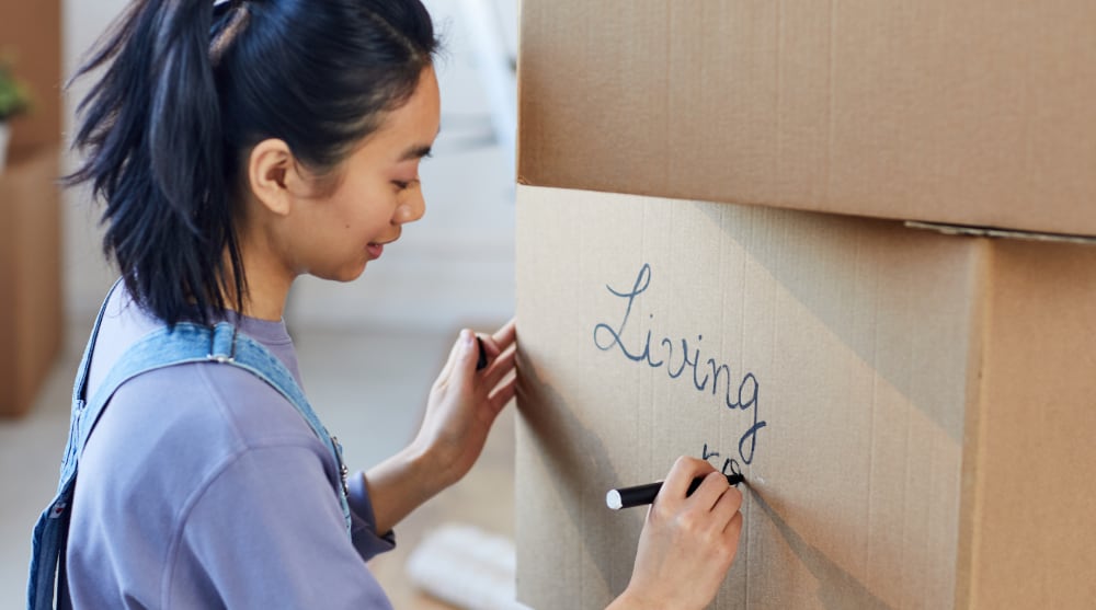 How to Pack for a Move — A Complete Guide young asian woman packing boxes for moving out 2021 09 24 04 08 38 utc
