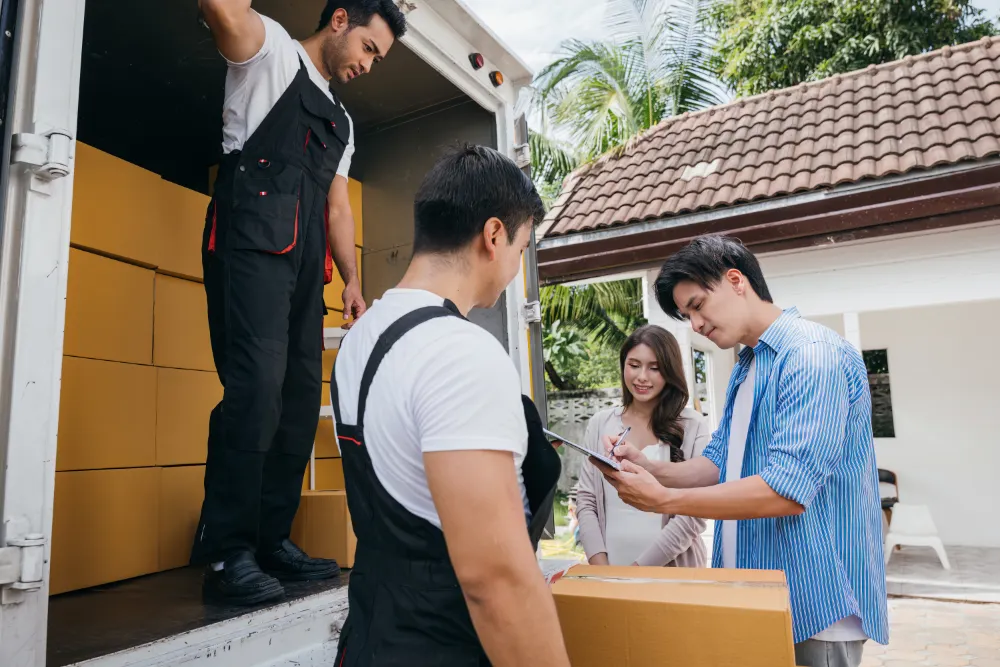 How to Choose the Right Long-Distance Moving Company professional movers assist a satisfied couple in s 2024 04 23 17 51 28 utc