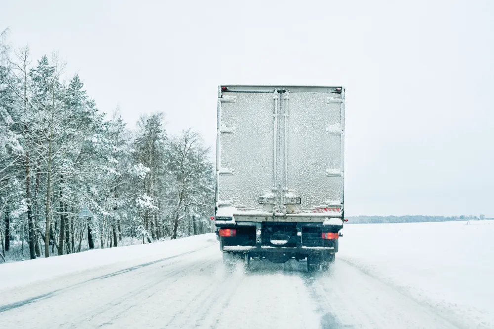 Moving in the winter: Your essential guide snowy road in winter forest with moving car 2023 11 27 05 36 36 utc