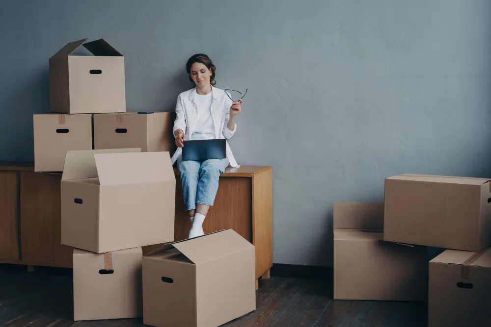 Moving in the winter: Your essential guide female with carton boxes searching moving company 2023 11 27 04 56 58 utc