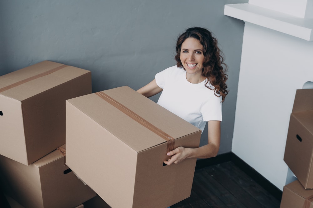 Eco-Friendly Moving: How to Make Your Next Move Green and Sustainable joyful female homeowner standing in new house hold 2023 11 27 05 27 55 utc