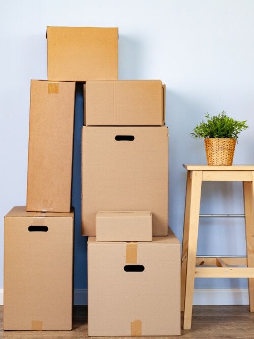 Eco-Friendly Moving: How to Make Your Next Move Green and Sustainable moving boxes with packed stuff and chair for movin 2023 11 27 04 53 01 utc edited