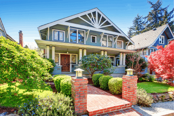 Exterior view of large, blue American craftsman-style home in Elmwood, Berkeley, CA.