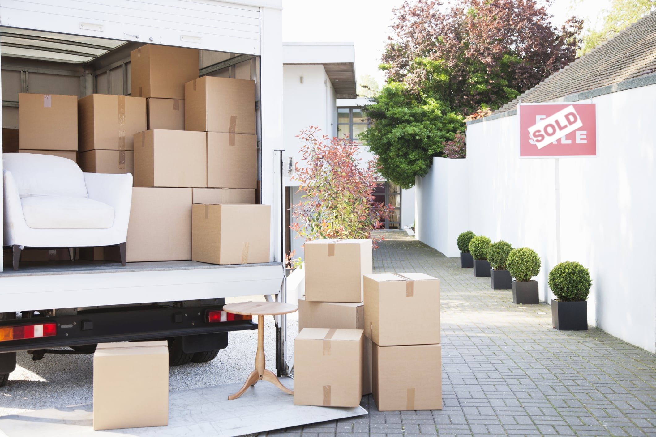 Boxes on ground near moving van in Los Angeles, CA.