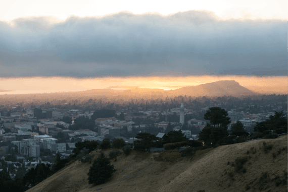 A beautiful sunset occurs over the city and campus of Berkeley and Albany, CA, which lies on the east shores of San Francisco Bay in Northern California.